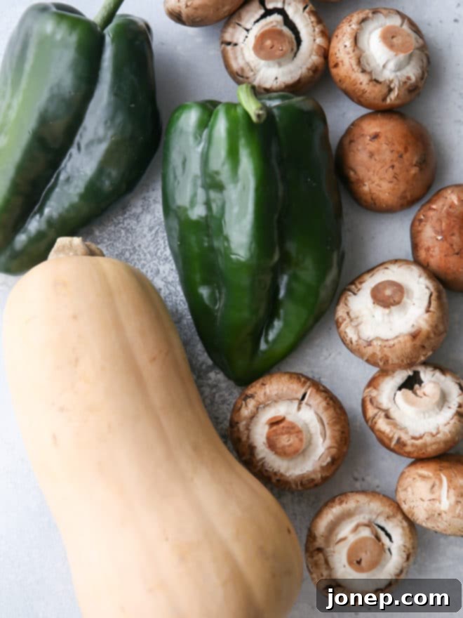 A close-up shot of the butternut squash, mushroom, and poblano enchilada filling being mixed