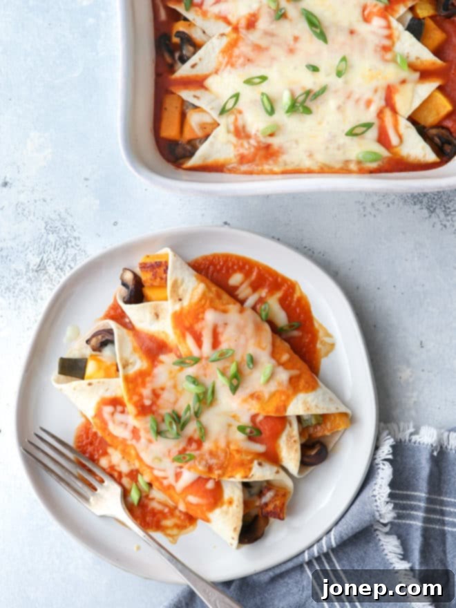 Close-up of baked enchiladas with butternut squash, mushrooms and poblano peppers, ready to serve