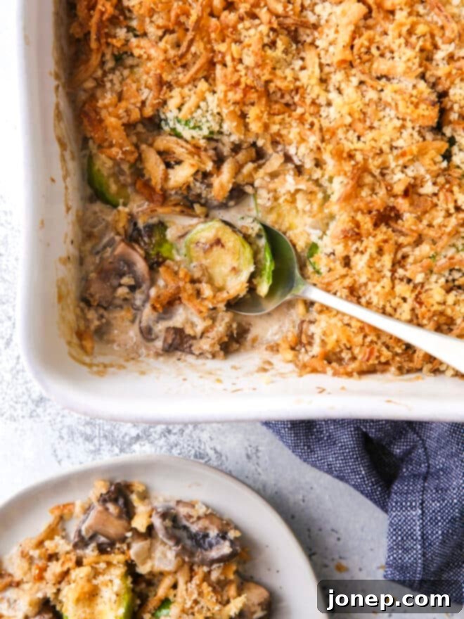 scooping brussels sprout and mushroom casserole out of baking dish