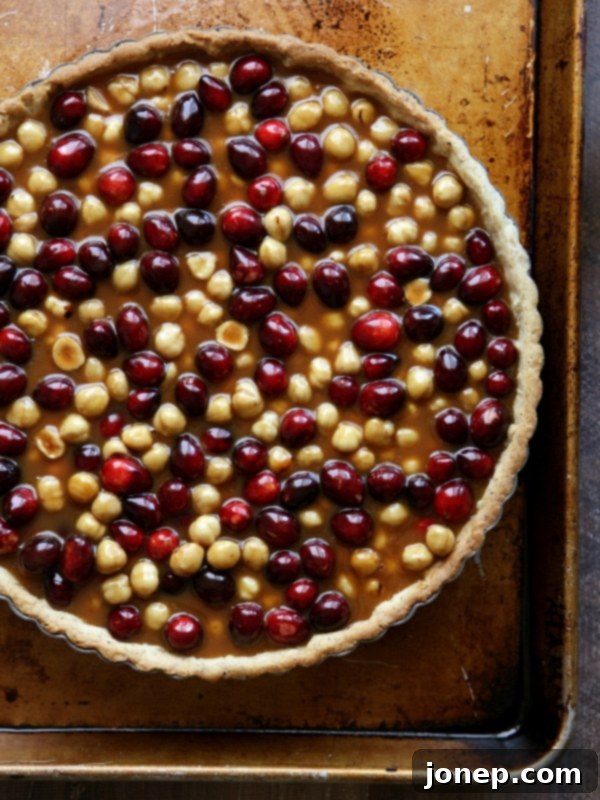 Cranberry Caramel Hazelnut Tart served with a dollop of whipped cream