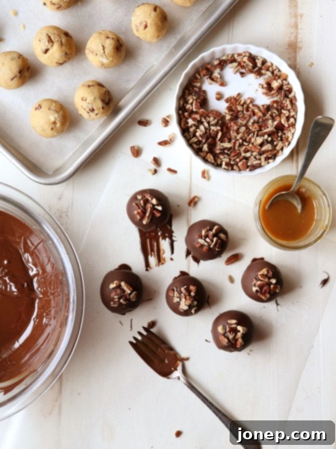 Finished Turtle Cookie Truffles on a parchment-lined baking sheet, ready to be enjoyed or gifted | completelydelicious.com