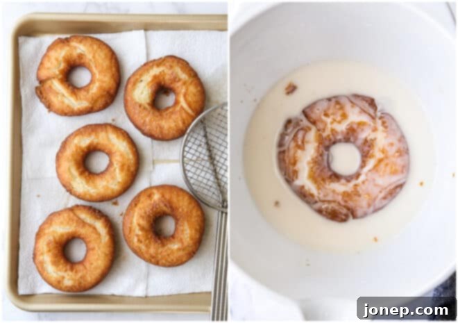 Dipping a freshly fried old-fashioned doughnut into a bowl of vanilla glaze.