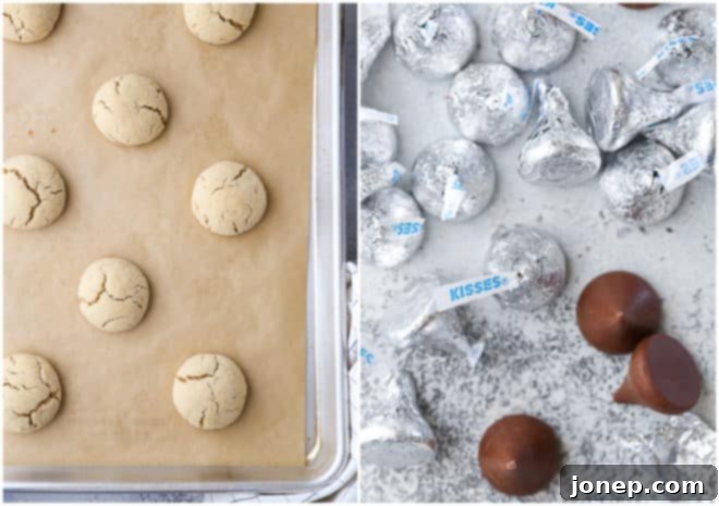 Close-up of baked peanut butter cookies, perfectly puffed and cracked, ready for Hershey's Kisses