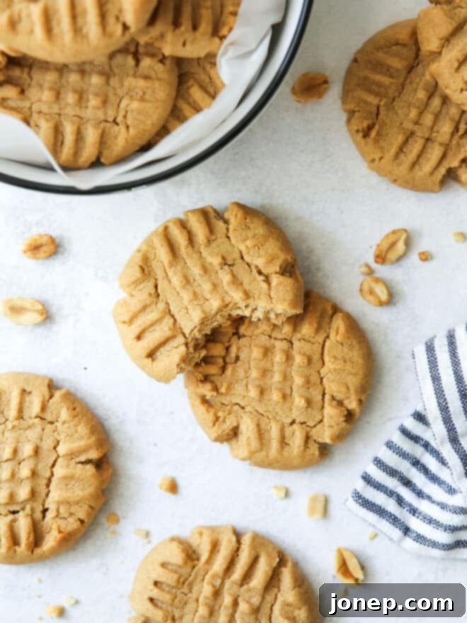 A stack of perfectly baked classic peanut butter cookies, showcasing their soft texture.