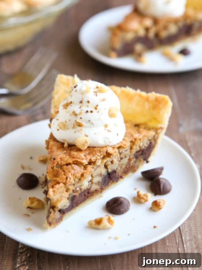 slices of toll house cookie pie on plates with whipped cream