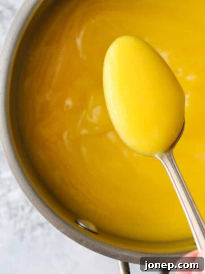 Delicious Homemade Lemon Curd 5 spoon of lemon curd in a pot