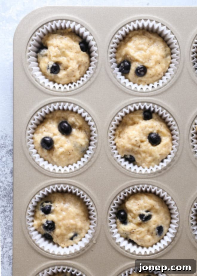 Close-up of a tender, moist blueberry muffin revealing browned butter bits