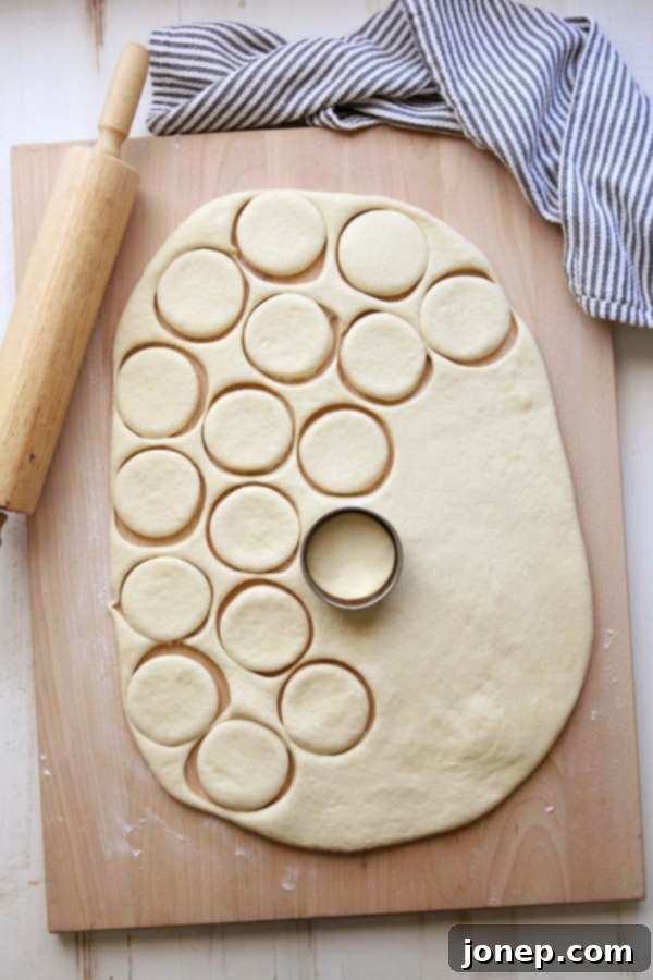 Homemade Parker House Rolls stacked on a plate
