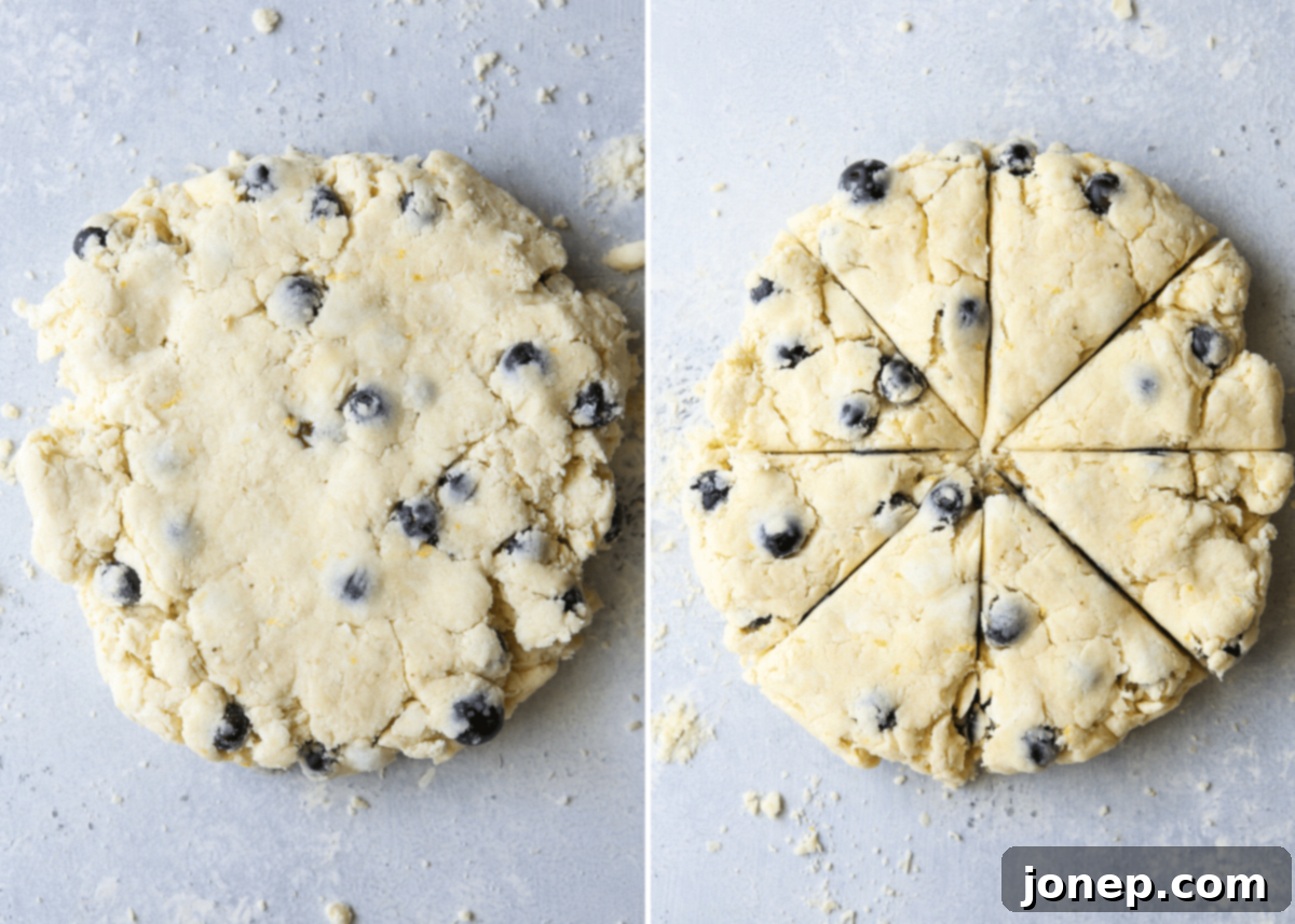Mixing heavy cream and fresh blueberries into shaggy scone dough with a spatula