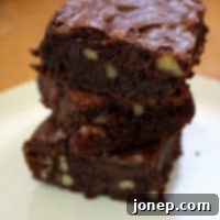 Decadent Triple Chocolate Walnut Brownies 2 Delicious Fudge Brownies with Walnuts, topped with a rich chocolate glaze