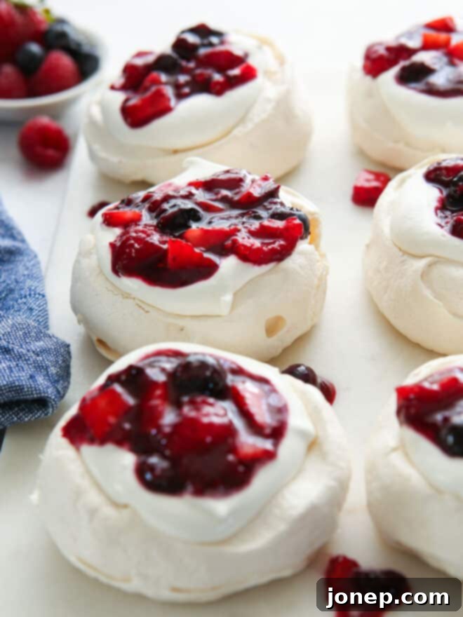 Vibrant Berry Cloud Pavlova 8 close up of mini berry pavlovas on a serving platter