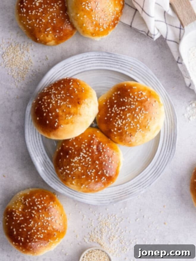 Fluffy Homemade Burger Buns 11 homemade hamburger buns on a plate
