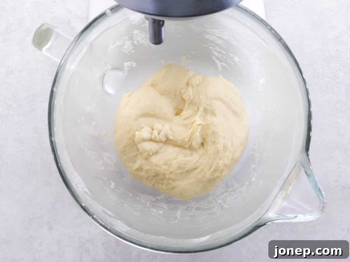 burger bun dough in bowl after first rise