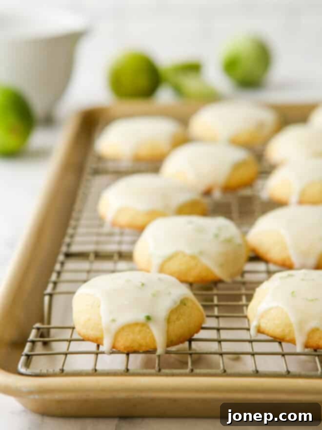 Zesty Lime Cornmeal Delights 8 Glazed lime cornmeal cookies arranged on a wire rack, allowing the icing to set.