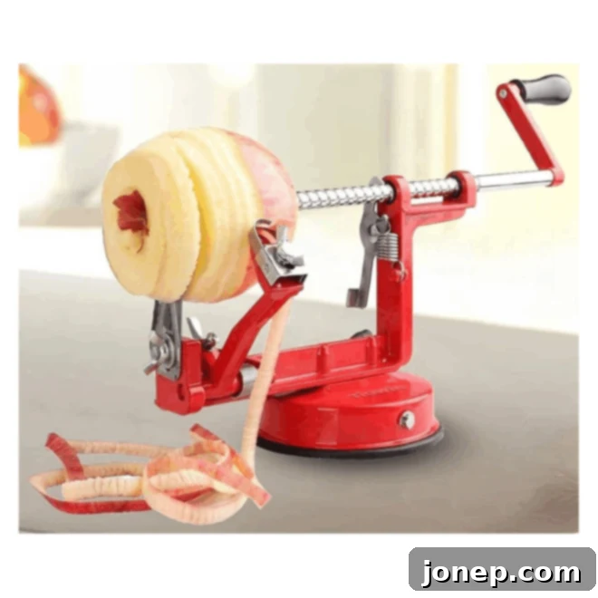 Crisp Apple Comforts for Autumn 3 A silver 3-in-1 apple peeler, corer, and slicer tool resting on a kitchen counter, ready for use.