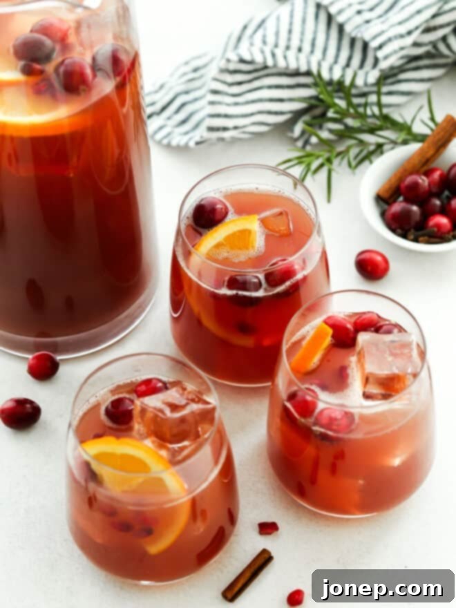Holiday punch in individual glasses with pitcher in background