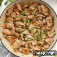 Stir-fried Thai lemongrass pork in a skillet, ready to be served.