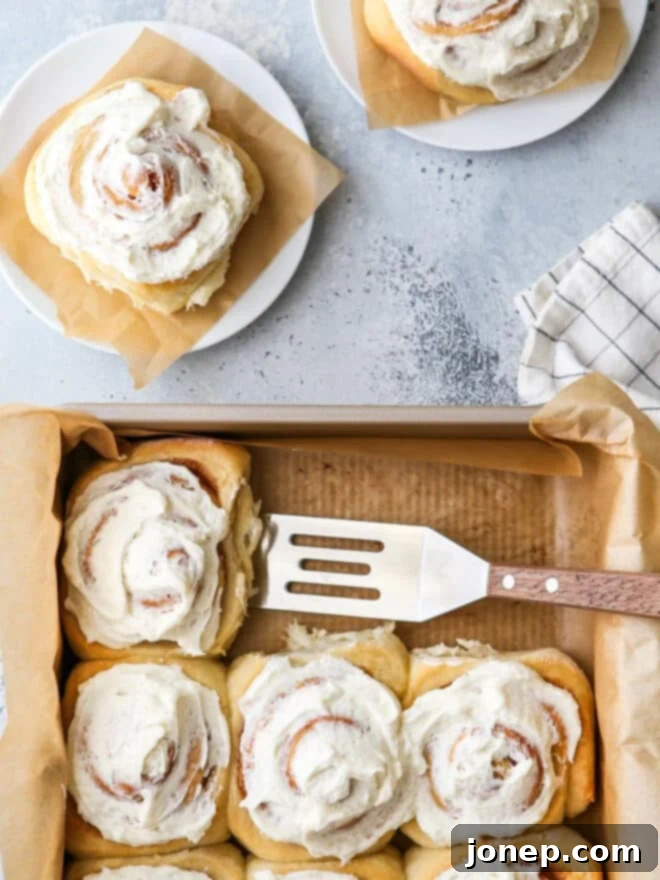Snug Saturday Treats 7 Cinnamon rolls being dished up onto a plate: a cozy weekend baking project
