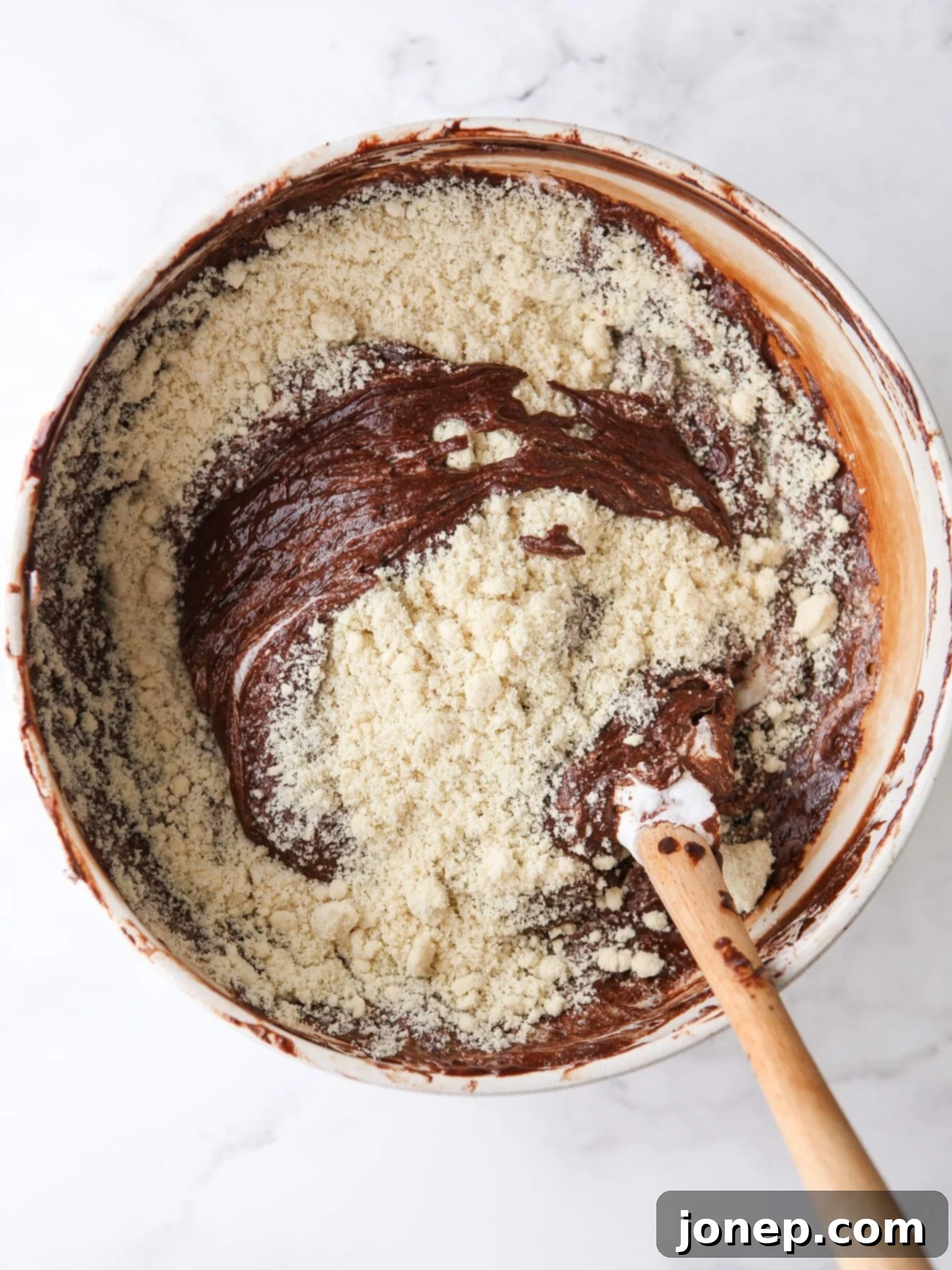 Snug Saturday Treats 5 Folding almond flour into a rich chocolate cake batter