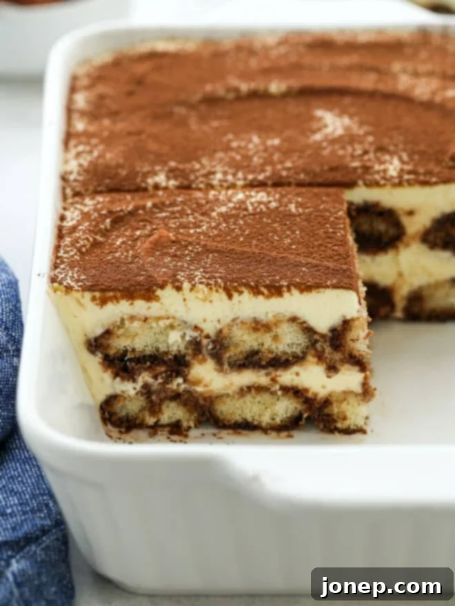 Timeless Italian Tiramisu 3 A dish of sliced tiramisu, revealing the beautiful layers of ladyfingers and mascarpone cream.